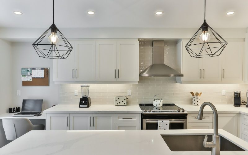 white wooden kitchen cabinet with black pendant lamp